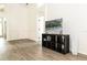 Open living area with wood floors, view of the pool, and a black TV stand with storage at 14324 Moon Flower Dr, Tampa, FL 33626