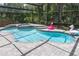 Beautiful screened pool area with fun, colorful inflatables and lush backyard surroundings at 14324 Moon Flower Dr, Tampa, FL 33626