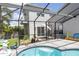 Enclosed pool area with view of two-story home, featuring outdoor seating and patio at 14324 Moon Flower Dr, Tampa, FL 33626