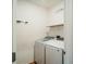 Laundry room with washer, dryer, and shelving at 14368 Ermine Owl Rd, Weeki Wachee, FL 34614