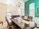 Bright dining room features a wood table and chairs, chandelier, and accent wall at 17853 Green Willow Dr, Tampa, FL 33647