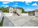 Backyard with large concrete patio and white fence at 205 W 122Nd Ave, Tampa, FL 33612