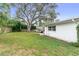 Spacious backyard with large tree and patio seating area at 2248 Saint Charles Dr, Clearwater, FL 33764