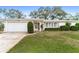 Charming ranch house with a well-manicured lawn and attached garage at 2248 Saint Charles Dr, Clearwater, FL 33764