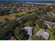An aerial view of the property and neighborhood surrounded by lush trees at 2640 Westchester N Dr, Clearwater, FL 33761