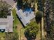 Aerial view of house with large backyard and mature trees at 2640 Westchester N Dr, Clearwater, FL 33761