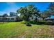 Picturesque backyard with mature trees, playground, firepit and a fenced in yard at 2640 Westchester N Dr, Clearwater, FL 33761
