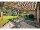 Backyard patio with pergola, outdoor grill and well-manicured lawn at 2640 Westchester N Dr, Clearwater, FL 33761