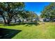 Large grassy backyard with playset and firepit at 2640 Westchester N Dr, Clearwater, FL 33761
