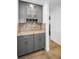 Stylish wet bar with elegant cabinetry, granite counters, and glass shelves, perfect for entertaining at 2640 Westchester N Dr, Clearwater, FL 33761