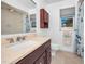 Bright bathroom featuring a large vanity, toilet, window, and neutral color scheme at 2640 Westchester N Dr, Clearwater, FL 33761