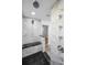 Luxury bathroom featuring marble walls, a rain shower, and a granite bench at 2640 Westchester N Dr, Clearwater, FL 33761