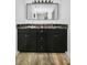 Modern bathroom vanity featuring double sinks, granite counters, and sleek black cabinets at 2640 Westchester N Dr, Clearwater, FL 33761