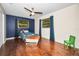 Charming bedroom with hardwood floors, two windows, and a boat-shaped bed at 2640 Westchester N Dr, Clearwater, FL 33761