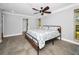 Bright bedroom with two windows, a ceiling fan, and neutral tones, providing a relaxing atmosphere at 2640 Westchester N Dr, Clearwater, FL 33761