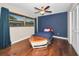 Cozy bedroom with hardwood floors, a boat-shaped bed, and natural light at 2640 Westchester N Dr, Clearwater, FL 33761