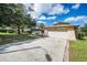 A single-Gathering home with a two car garage and well-manicured lawn, set against a blue sky at 2640 Westchester N Dr, Clearwater, FL 33761