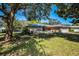 Lovely single-story home with a spacious, grassy front yard and mature trees at 2640 Westchester N Dr, Clearwater, FL 33761