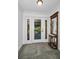 Bright foyer with decorative front door, mirror and slate tile flooring at 2640 Westchester N Dr, Clearwater, FL 33761
