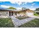 Inviting single-story home boasts a well-manicured lawn and attached garage at 2640 Westchester N Dr, Clearwater, FL 33761