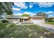 Charming single-story home featuring a two-car garage, mature trees, and a well-manicured lawn at 2640 Westchester N Dr, Clearwater, FL 33761