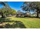 Property featuring a large, grassy front lawn and mature trees, offering ample space at 2640 Westchester N Dr, Clearwater, FL 33761