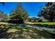 Landscaped front yard, fenced in, with mature trees enhancing the property's appeal at 2640 Westchester N Dr, Clearwater, FL 33761