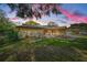 Single-story home at sunset with lush landscaping and a welcoming walkway at 2640 Westchester N Dr, Clearwater, FL 33761