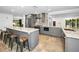 Open kitchen boasts granite countertops, stainless steel appliances, and an island with bar seating at 2640 Westchester N Dr, Clearwater, FL 33761