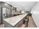 A spacious kitchen boasts granite counters, stainless appliances, an island with bar seating, and gray cabinets at 2640 Westchester N Dr, Clearwater, FL 33761