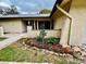 Close-up showcases beautiful landscaping with colorful flowers and decorative rocks at 2640 Westchester N Dr, Clearwater, FL 33761