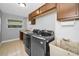 Well-equipped laundry room with modern appliances, sink, and ample counter space at 2640 Westchester N Dr, Clearwater, FL 33761