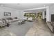 Bright living room features tile floors, neutral paint, and an open floorplan perfect for entertaining at 2640 Westchester N Dr, Clearwater, FL 33761