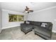 Relaxing living room featuring a ceiling fan, a comfortable sectional couch, and a sunny window at 2640 Westchester N Dr, Clearwater, FL 33761