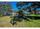A backyard playset with a slide and swings, ideal for Gathering fun and recreation at 2640 Westchester N Dr, Clearwater, FL 33761