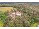 Aerial view of property showing home, metal carport, and surrounding trees at 302 E Keysville Rd, Plant City, FL 33567