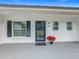 Modern front entrance with a black door, white brick exterior, and black shutters at 302 E Keysville Rd, Plant City, FL 33567