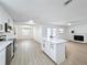 Open concept kitchen and living area with island and white cabinets at 302 E Keysville Rd, Plant City, FL 33567