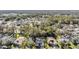 Aerial view of a residential neighborhood with mature trees and well-maintained homes at 35608 Welby Ct, Zephyrhills, FL 33541