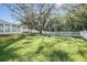 Spacious backyard with a large tree and fence at 35608 Welby Ct, Zephyrhills, FL 33541