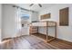 Bright bedroom featuring a wood frame bunk bed, light walls, and wood-look floors at 35608 Welby Ct, Zephyrhills, FL 33541