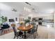 Open concept dining area with wood table and chairs, adjacent to living room and kitchen at 35608 Welby Ct, Zephyrhills, FL 33541