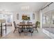 Bright dining room with a large window and a modern dining set at 35608 Welby Ct, Zephyrhills, FL 33541