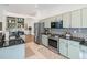 Modern kitchen with stainless steel appliances and light green cabinets at 35608 Welby Ct, Zephyrhills, FL 33541