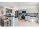 Modern kitchen with stainless steel appliances and light green cabinets at 35608 Welby Ct, Zephyrhills, FL 33541