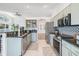 Modern kitchen with stainless steel appliances, granite countertops, and open shelving at 35608 Welby Ct, Zephyrhills, FL 33541