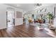 Bright living room boasts vaulted ceilings, hardwood floors and a large window with natural lighting at 35608 Welby Ct, Zephyrhills, FL 33541