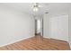 Bedroom with light walls, laminate floors, and double doors leading to a closet at 3722 Village Estates Pl, Tampa, FL 33618