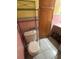 Pink tiled bathroom with toilet and metal shelving at 6035 Grand Blvd, New Port Richey, FL 34652