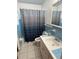 Bathroom with light blue tile and a shower/tub combo at 6035 Grand Blvd, New Port Richey, FL 34652